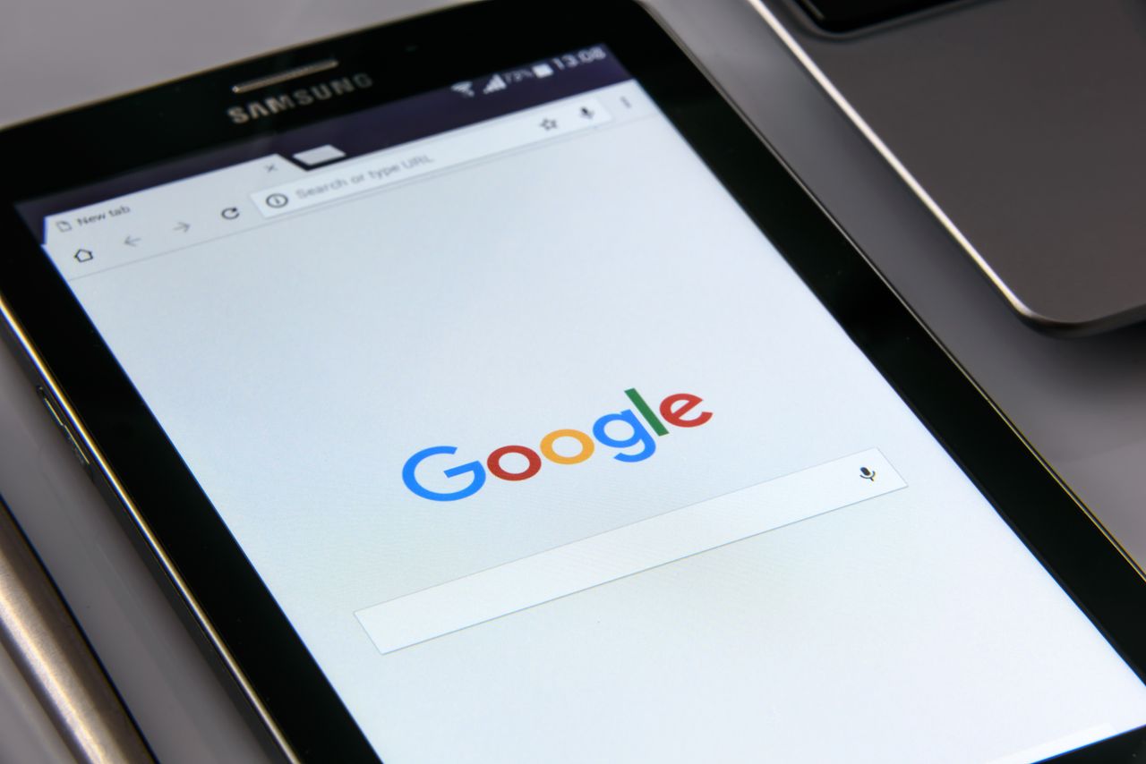 Close-up of a tablet displaying Googles search screen, emphasizing technology and internet browsing.